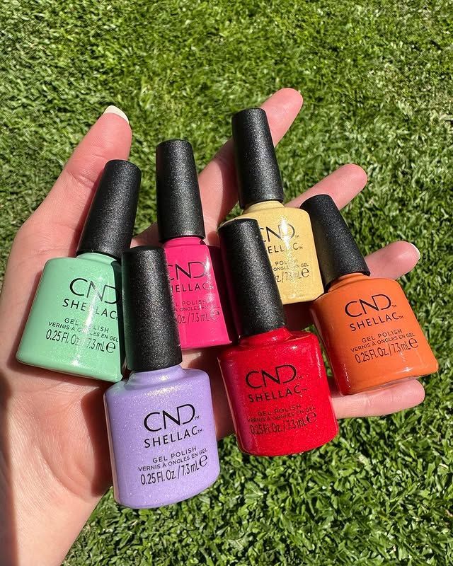 A Person is Holding a Bunch of Bottles of Nail Polish in Their Hand — Erikka's All Occasion Beauty In Rockhampton City, QLD