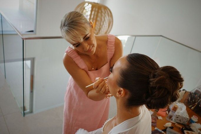 A Woman is Applying Makeup to Another Woman's Face — Erikka's All Occasion Beauty In Rockhampton City, QLD