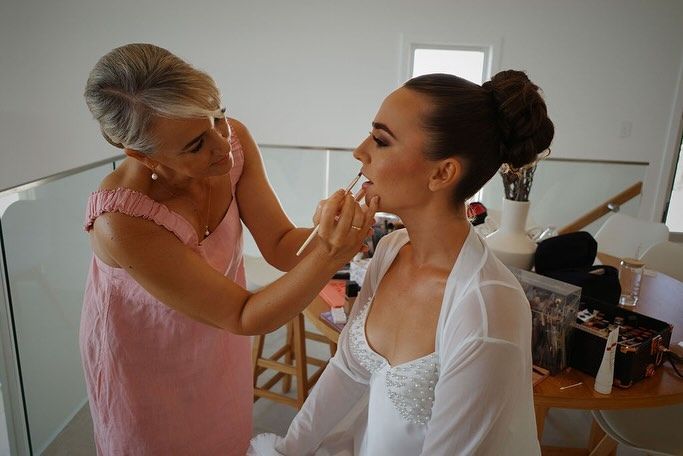 A Woman is Applying Makeup to a Woman's Face — Erikka's All Occasion Beauty In Rockhampton City, QLD
