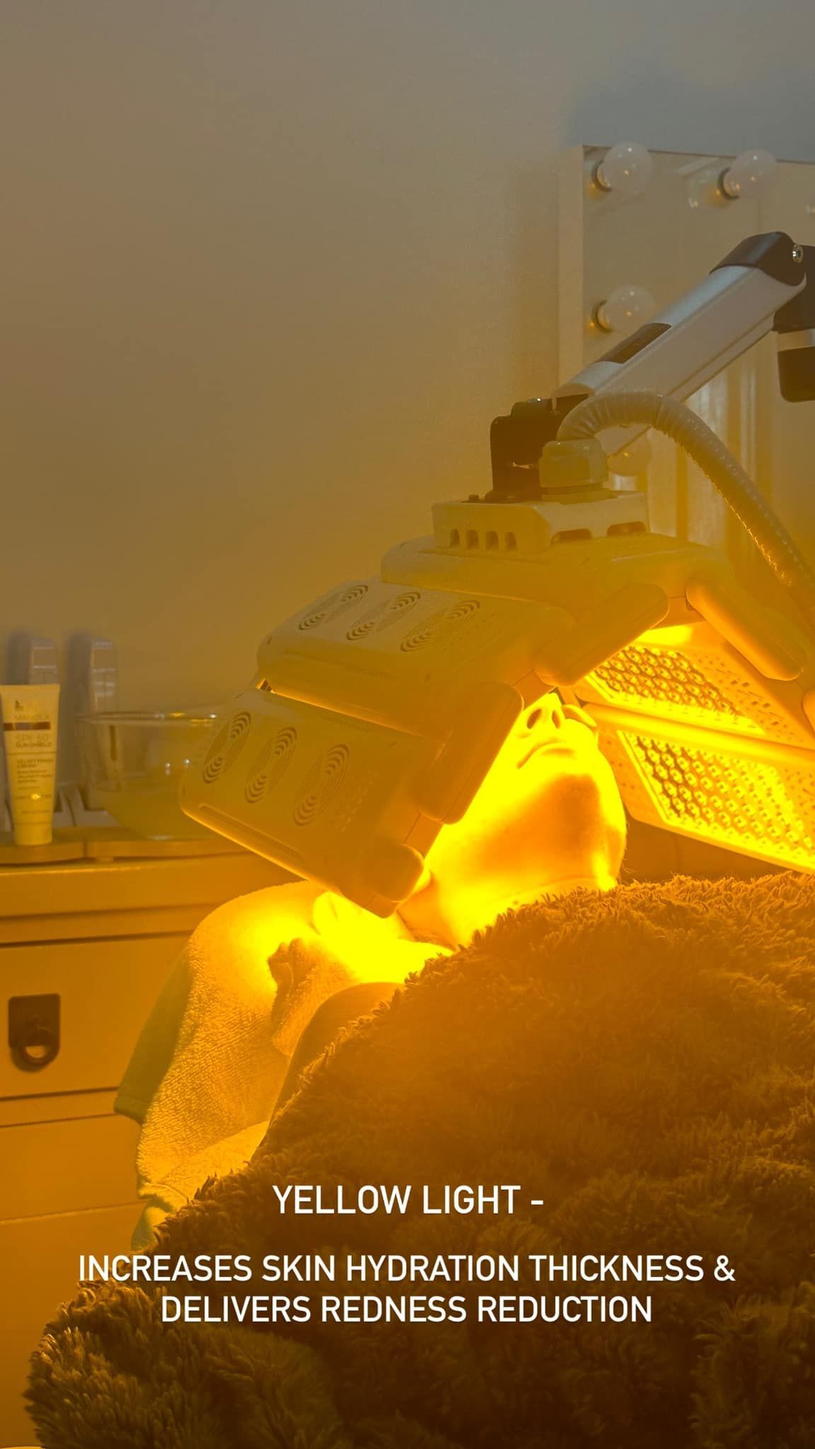 A Person is Getting a Yellow Light Treatment on Their Face — Erikka's All Occasion Beauty In Rockhampton City, QLD