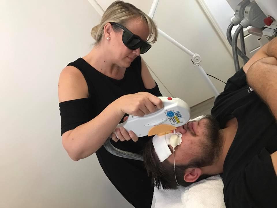 A Woman is Giving a Man a Laser Treatment on His Face — Erikka's All Occasion Beauty In Rockhampton City, QLD