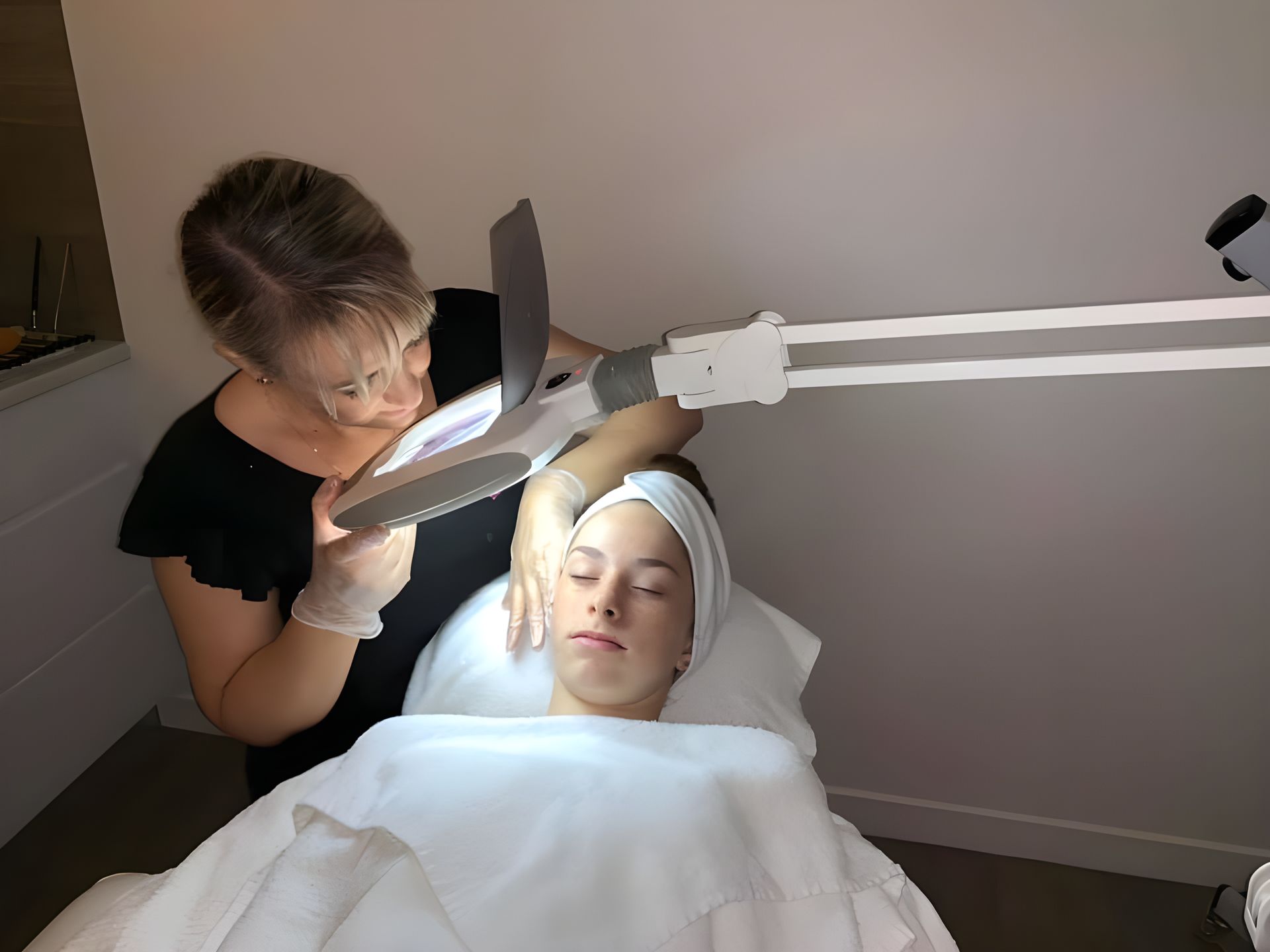 A Woman is Looking at a Woman's Face With a Magnifying Glass — Erikka's All Occasion Beauty In Rockhampton City, QLD