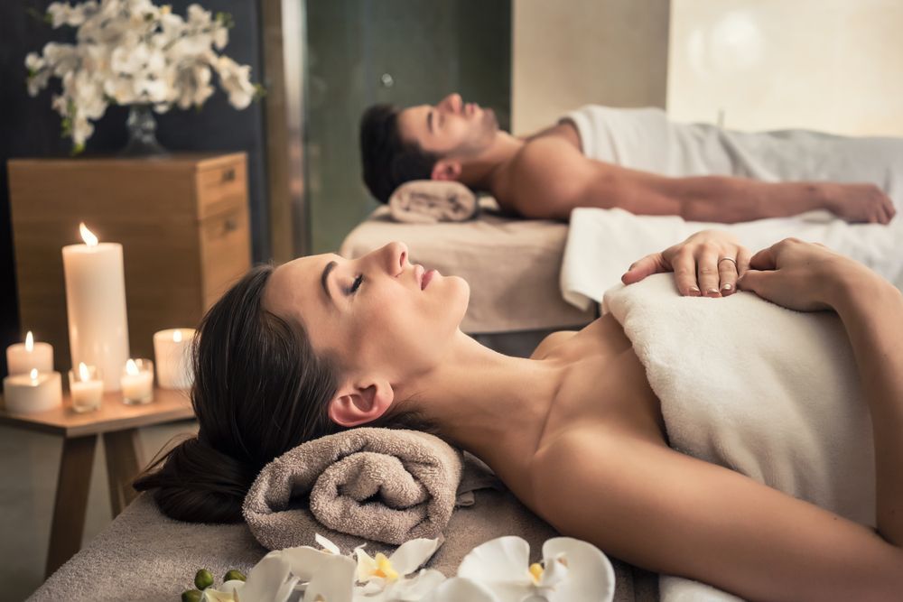 A Man and a Woman Are Laying on a Massage Table in a Spa — Erikka's All Occasion Beauty In Rockhampton City, QLD