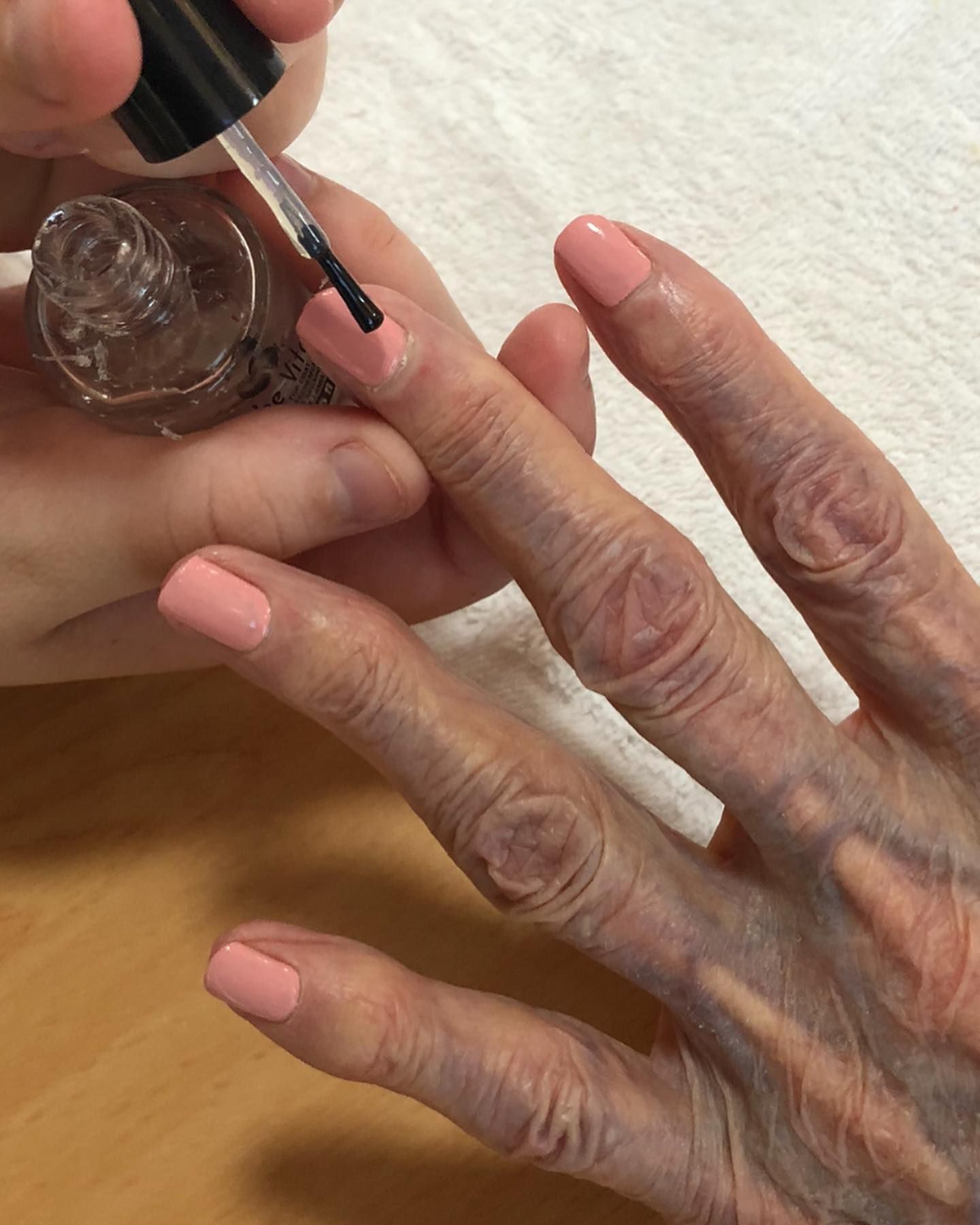 A Person is Applying Nail Polish to an Older Woman's Nails — Erikka's All Occasion Beauty In Rockhampton City, QLD