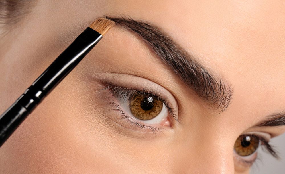 Close Up Correcting Eyebrow Shape With Brush — Erikka's All Occasion Beauty In Rockhampton City, QLD