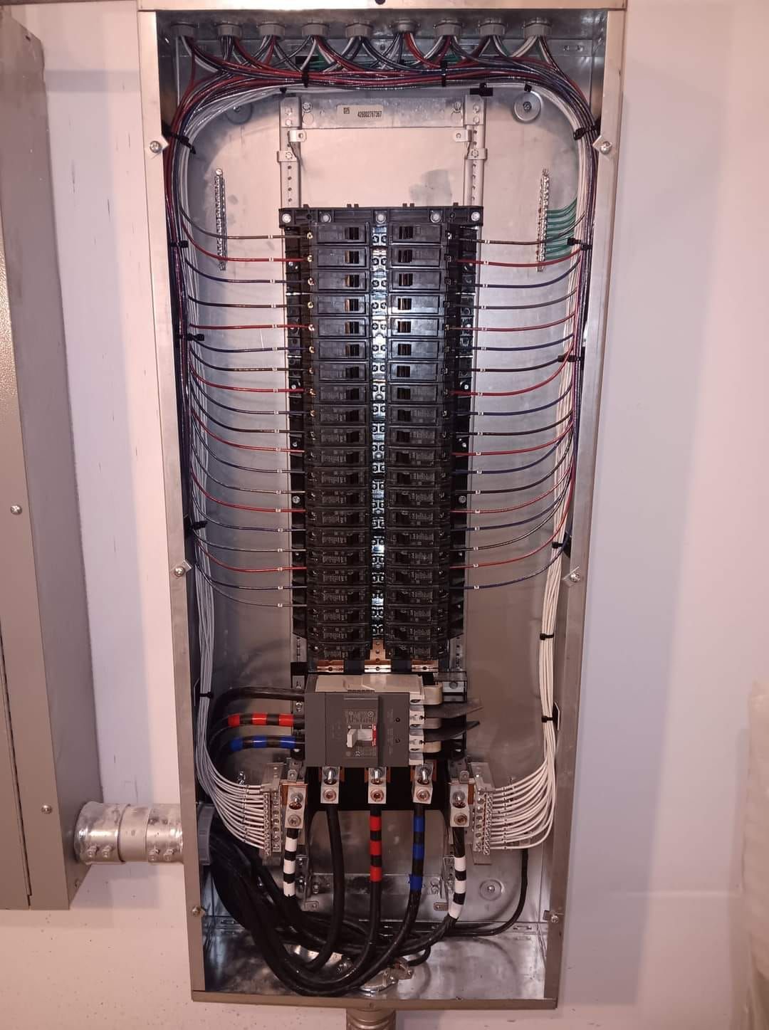 A large electrical box is hanging on a wall.