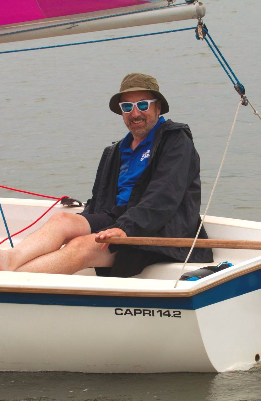 Seth Lewin is sitting on a boat that says capri 172