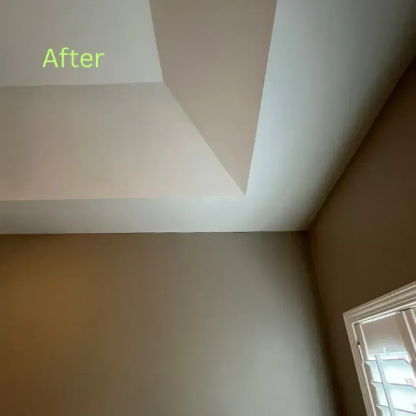 A room with a window and a ceiling that has been painted.