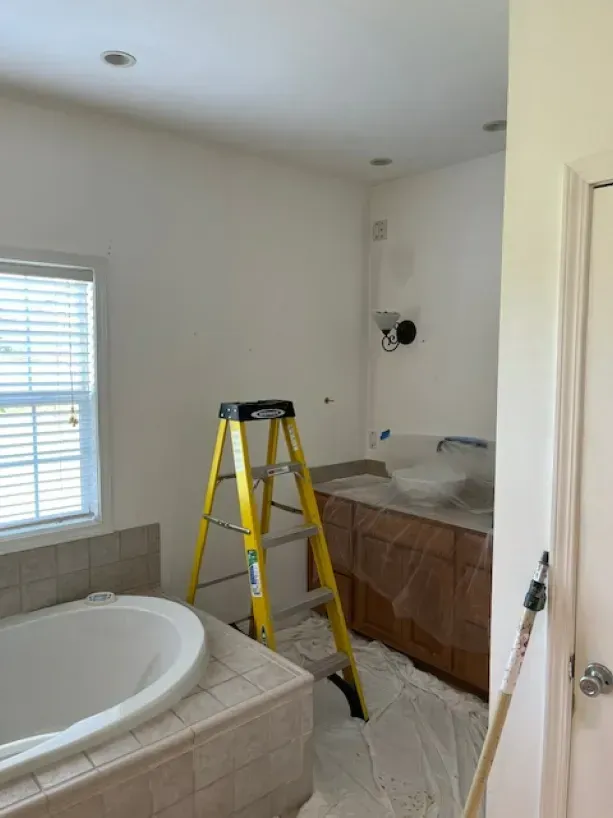 A bathroom with a bathtub and a ladder in it