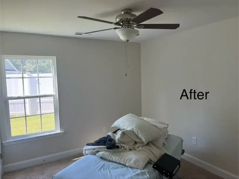 A bedroom with a bed and a ceiling fan and a sign that says after