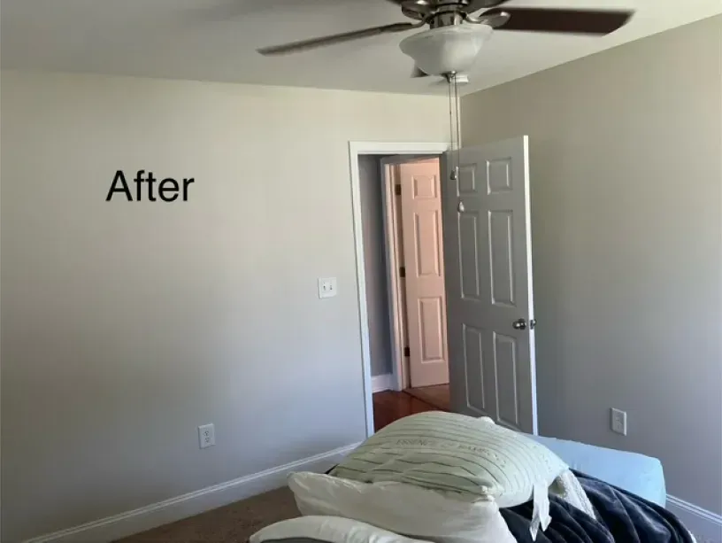A bedroom with a ceiling fan and a sign that says after
