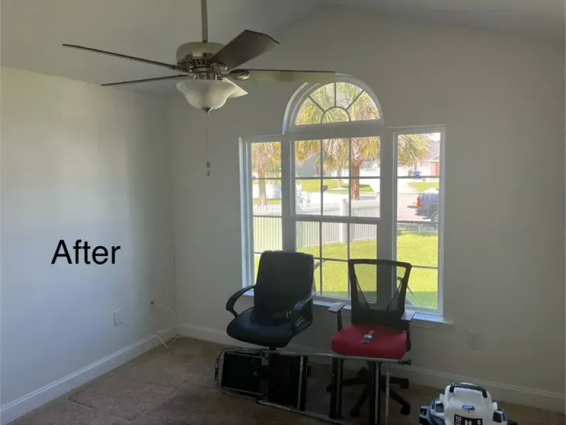 A room with a ceiling fan and a sign that says after