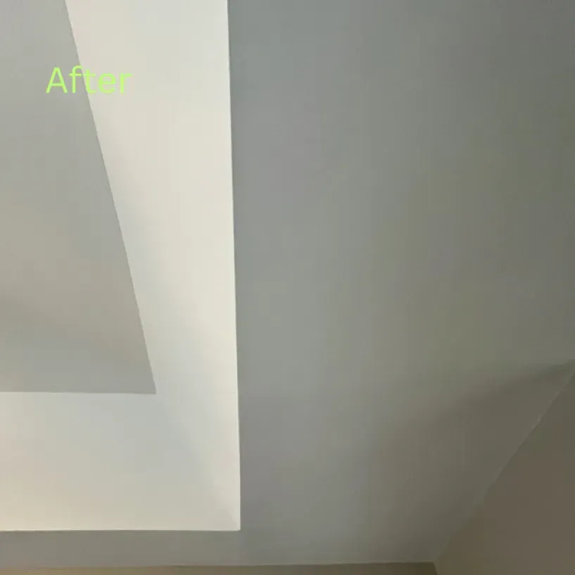 A close up of a white ceiling in a room.