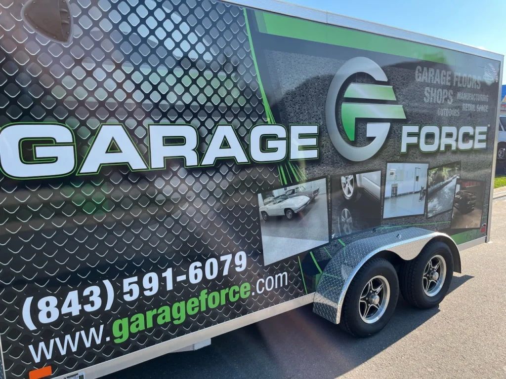 A garage g force trailer is parked on the side of the road