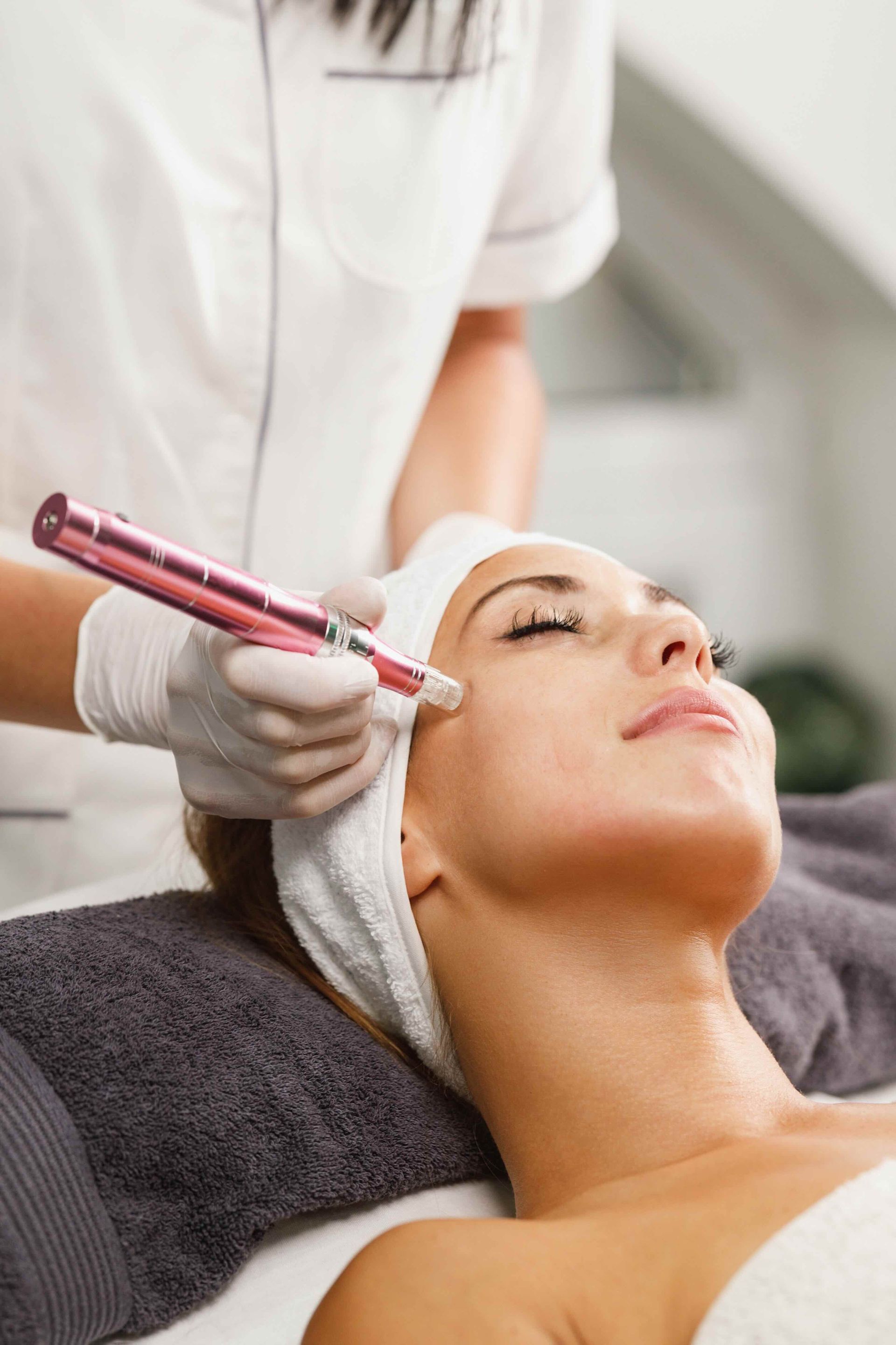 a woman is getting a microdermabrasion treatment on her face .