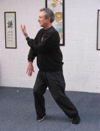 The Balanced Path At The Tai Chi Studio instructor doing a standing movement