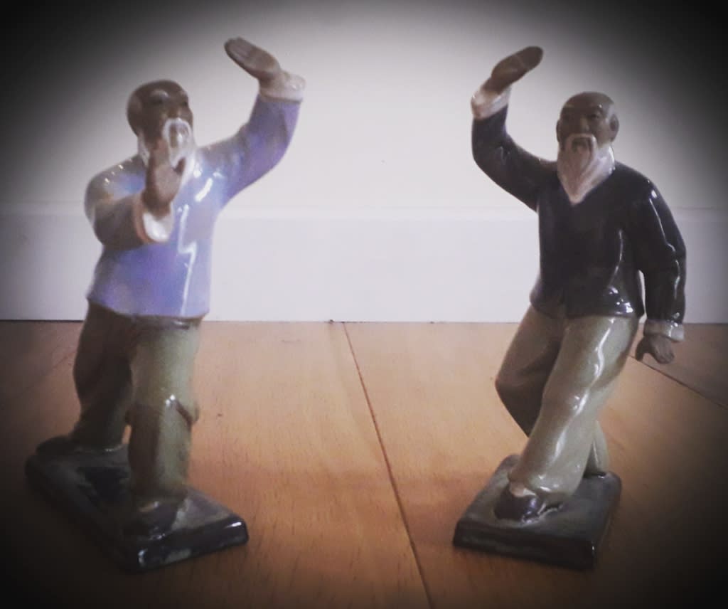 The Balanced Path At The Tai Chi Studio two statues