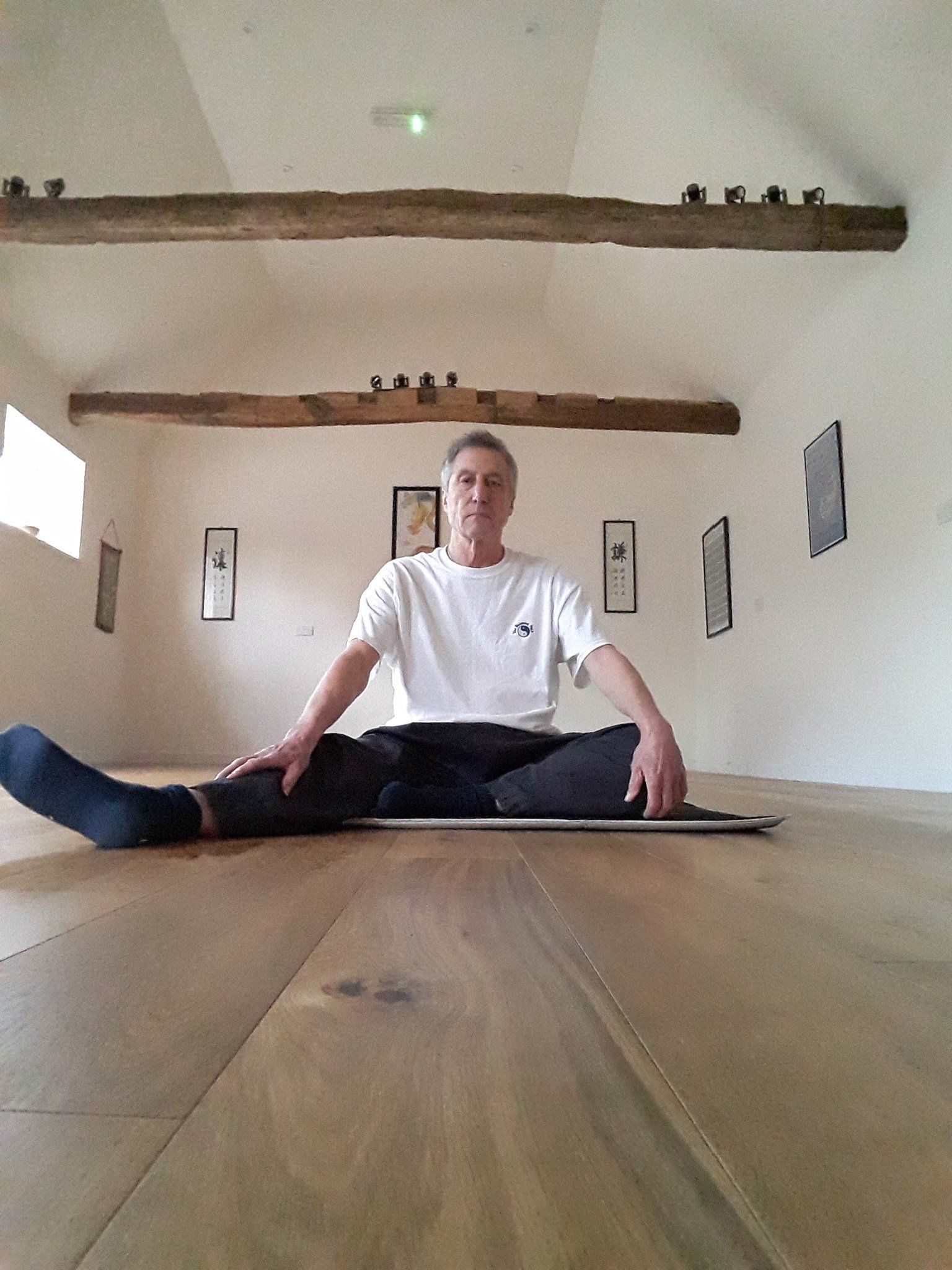 The Balanced Path At The Tai Chi Studio instructor doing sit down position with one leg out