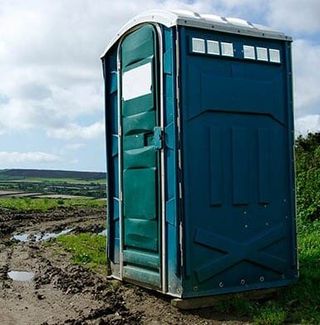 Portable Toilet In Muddy Field — Portable Toilets in Ypsilanti, MI