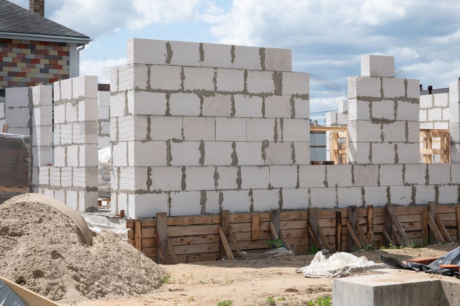 A building is being built with white bricks on a construction site.