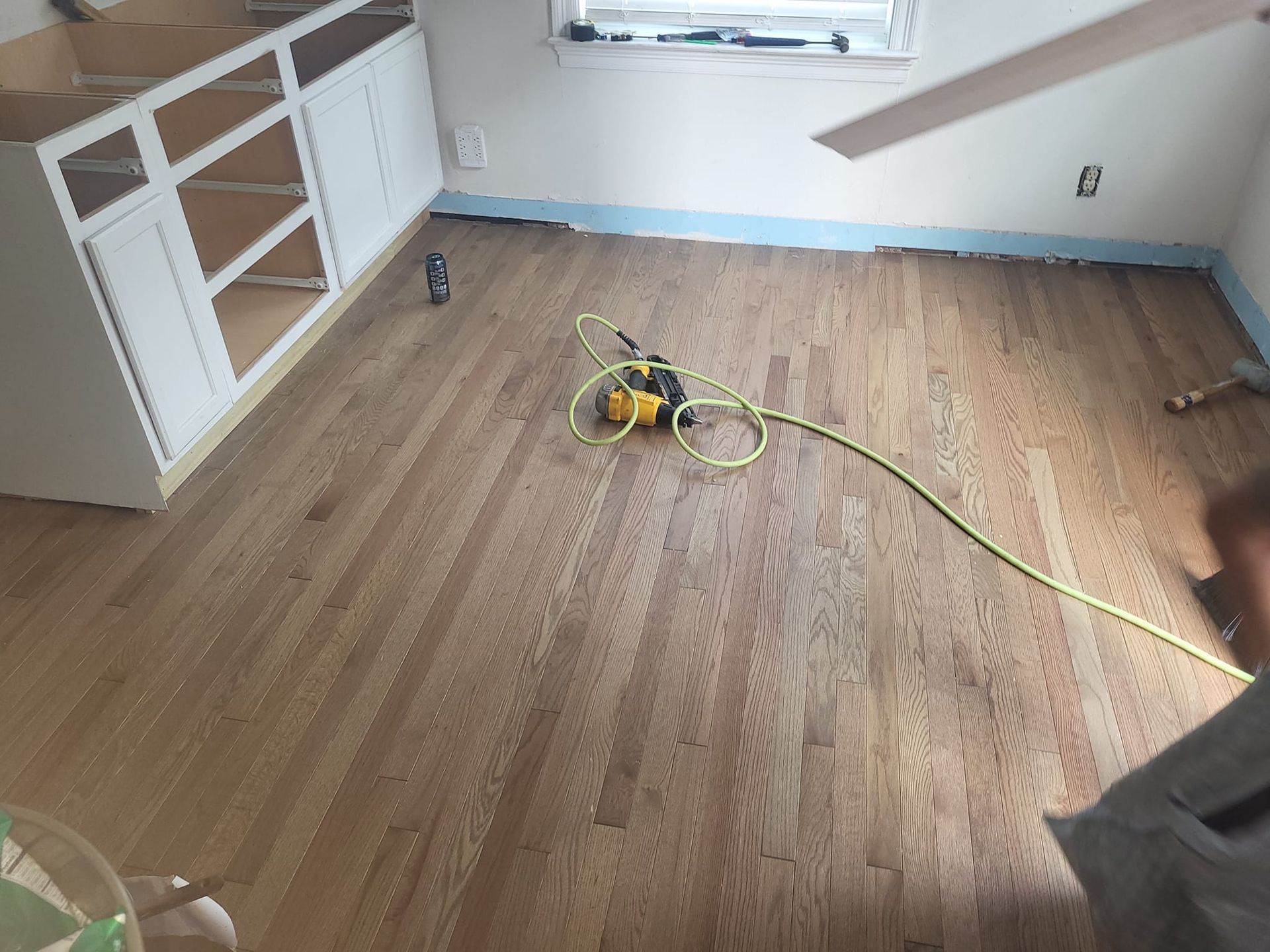 A room with hardwood floors and a ceiling fan