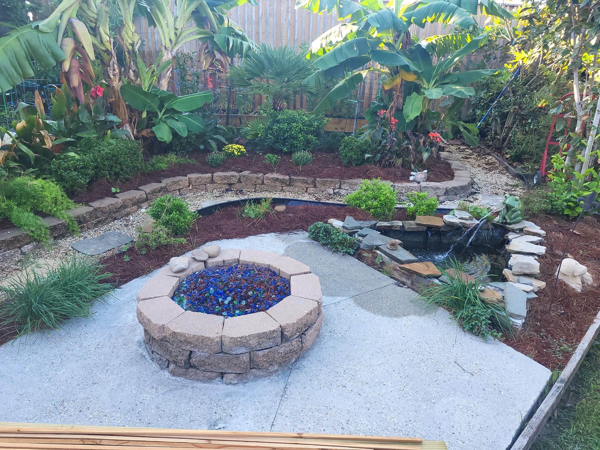 There is a fire pit in the middle of the backyard.