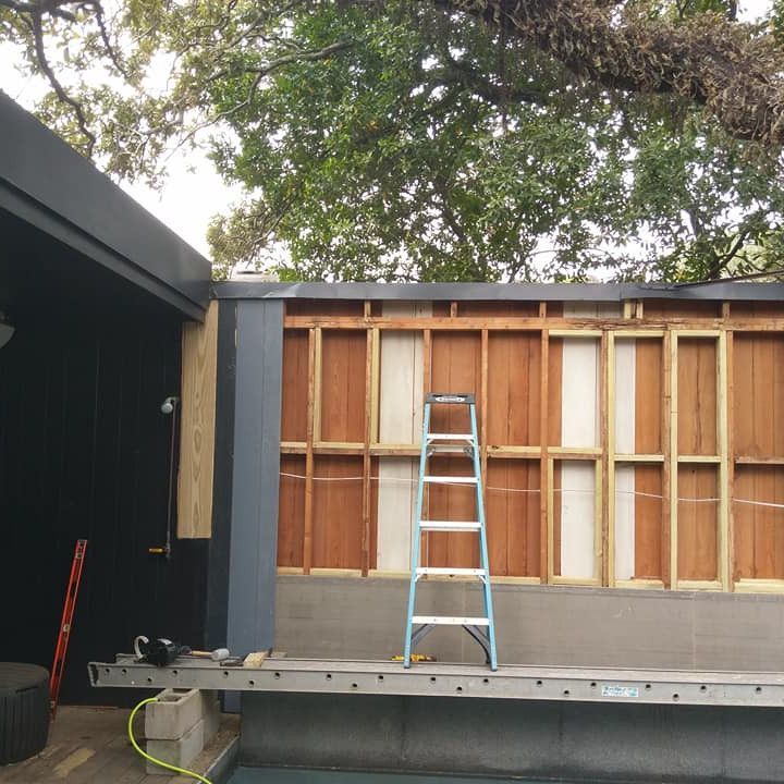A ladder is sitting in front of a building under construction