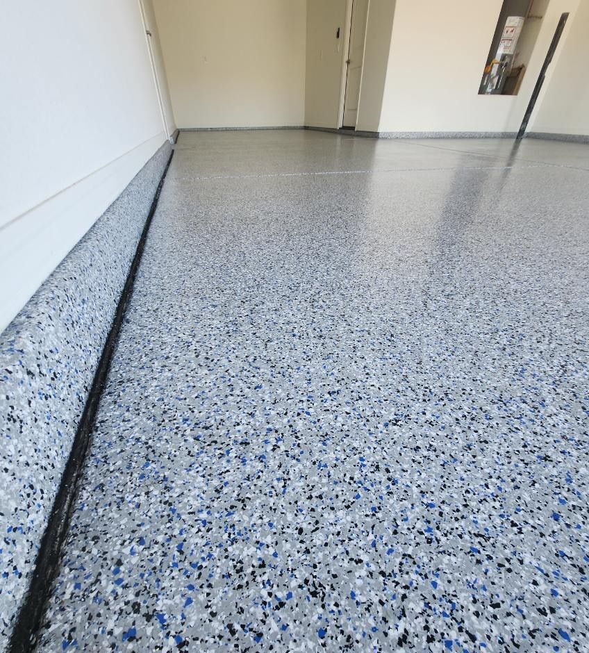 a close up of a gray and blue floor in a garage