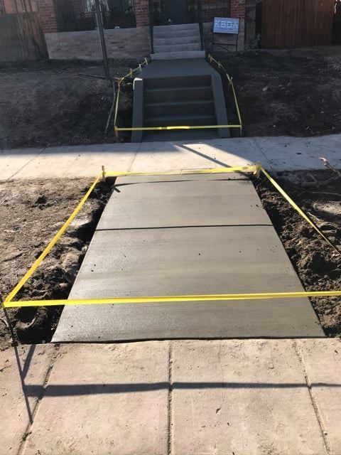 A concrete walkway is being built next to a set of stairs