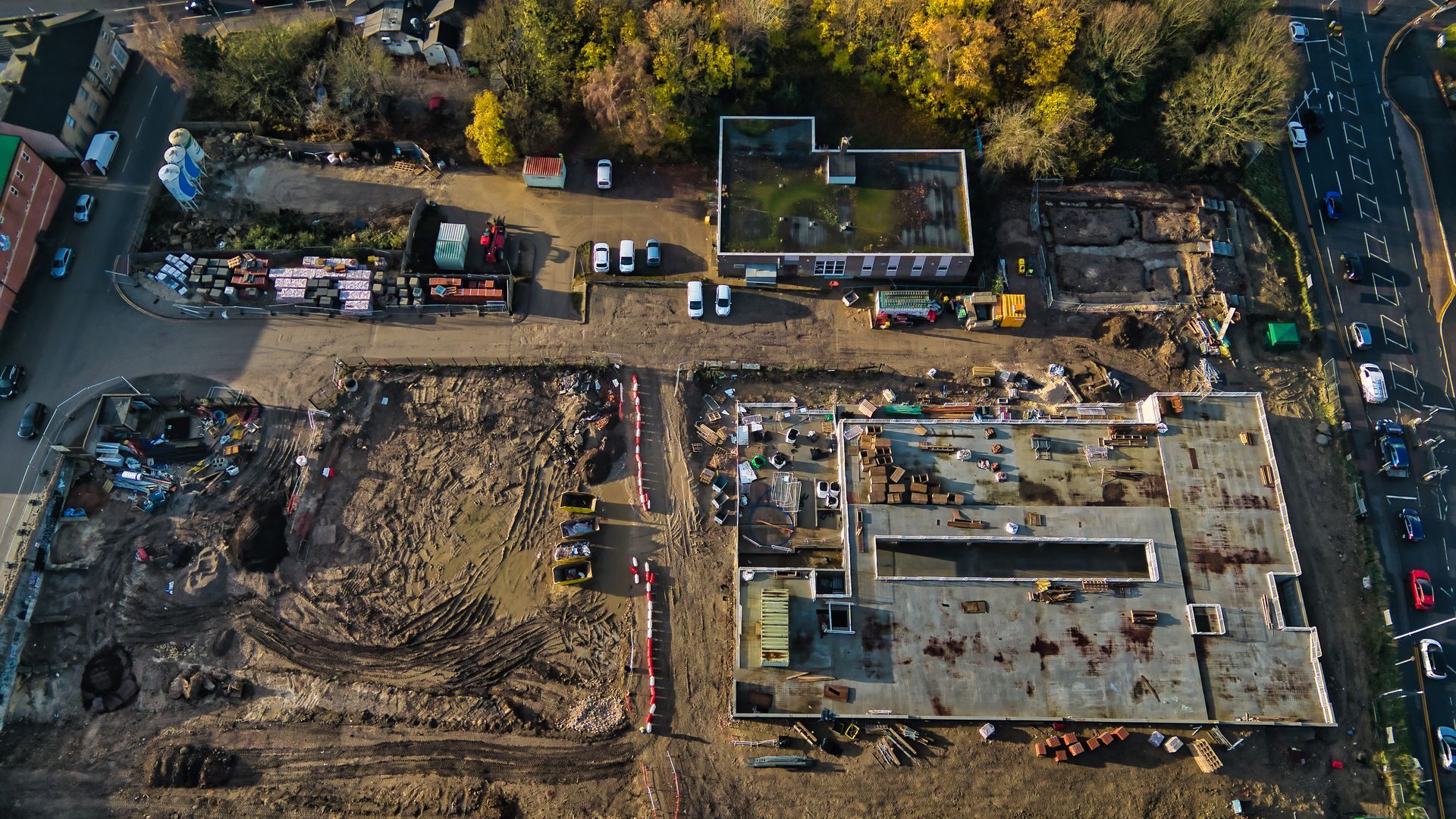 An aerial view of a building under construction in a city.