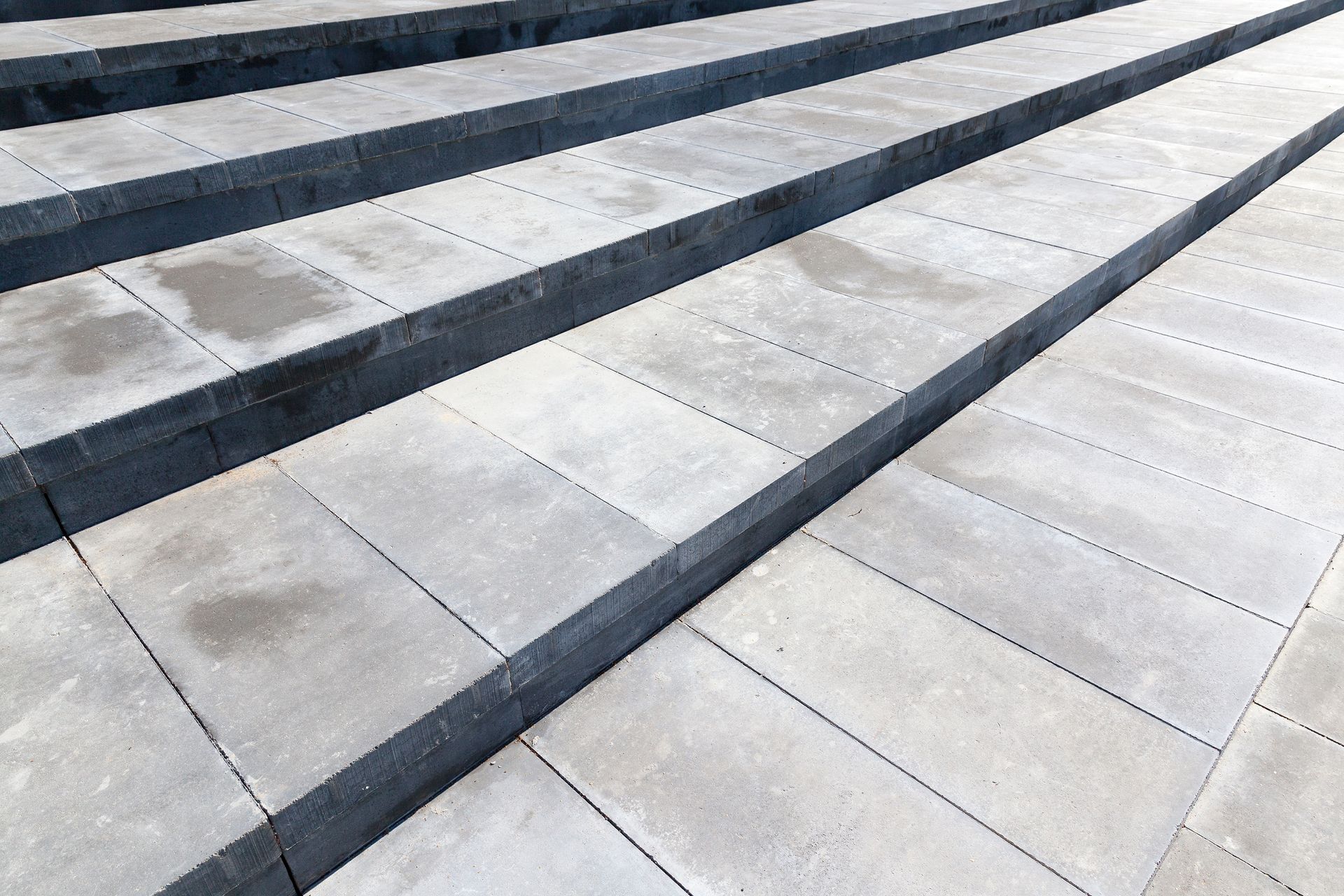A set of concrete stairs with a diagonal pattern