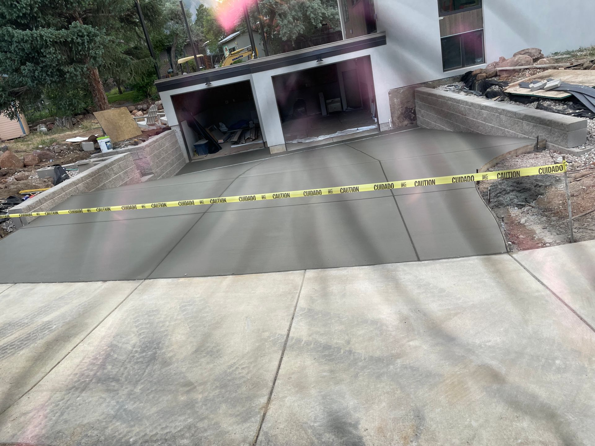 A concrete driveway is being built in front of a house.