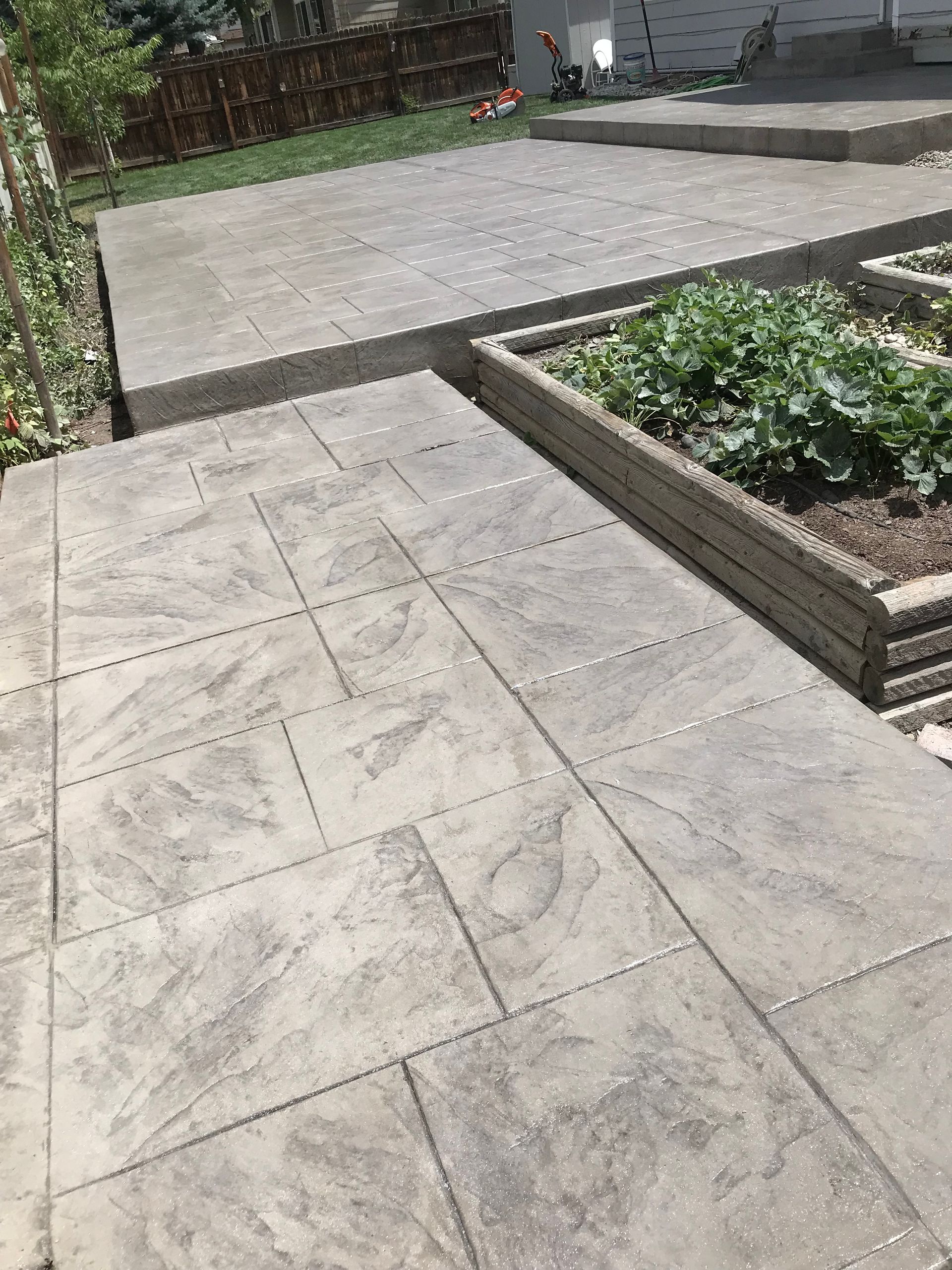 A brick walkway with a lamp post in the foreground