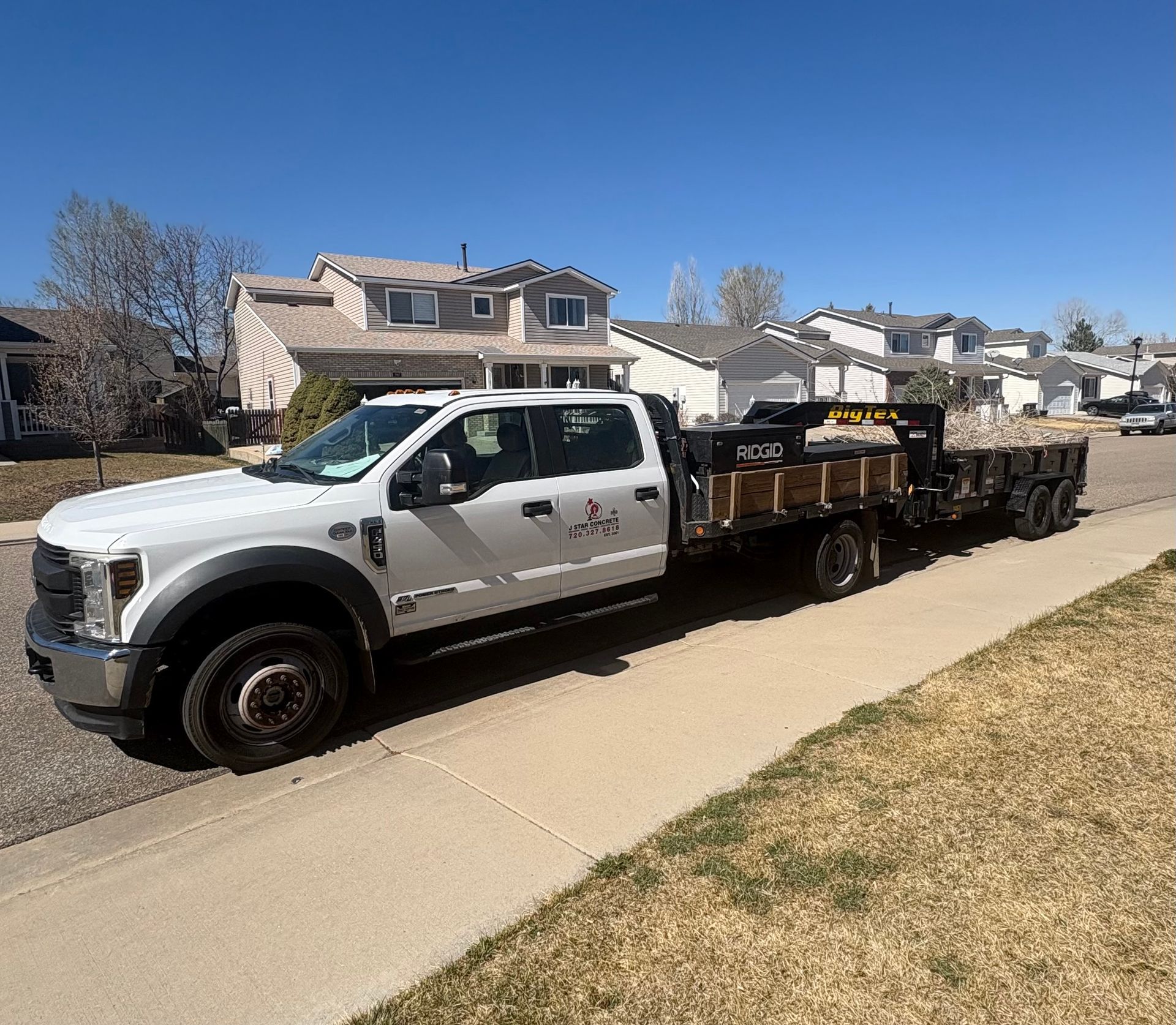 A backyard with a stone retaining wall and a wooden fence. A backyard with a stone retaining wall and a wooden fence.