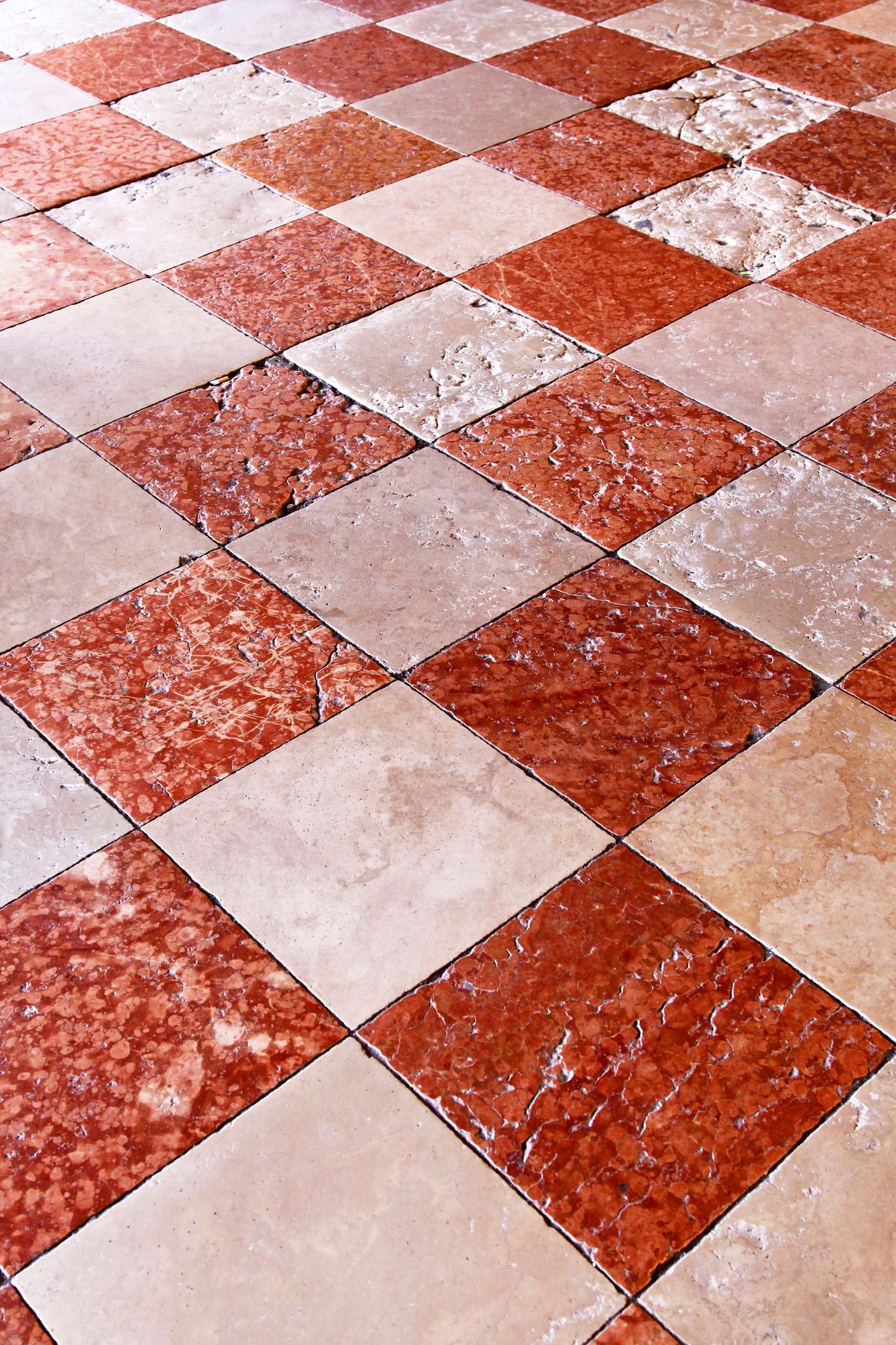 A close up of a red and white checkered tile floor.