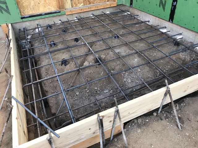 A concrete slab is being built in a wooden frame.