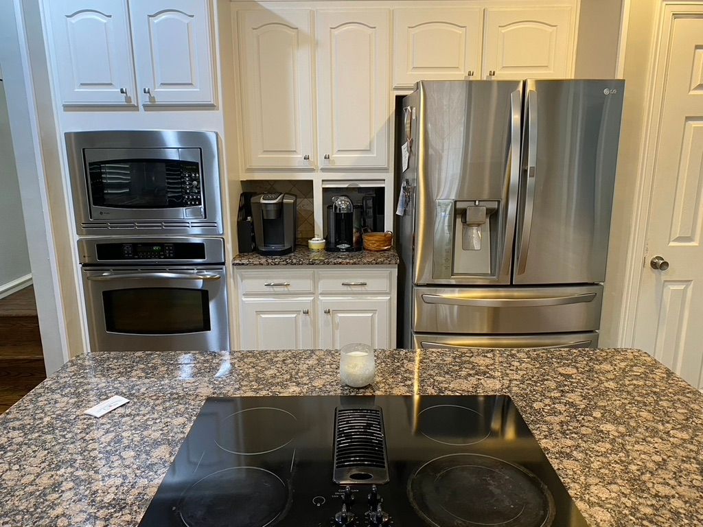 A kitchen with stainless steel appliances and granite counter tops