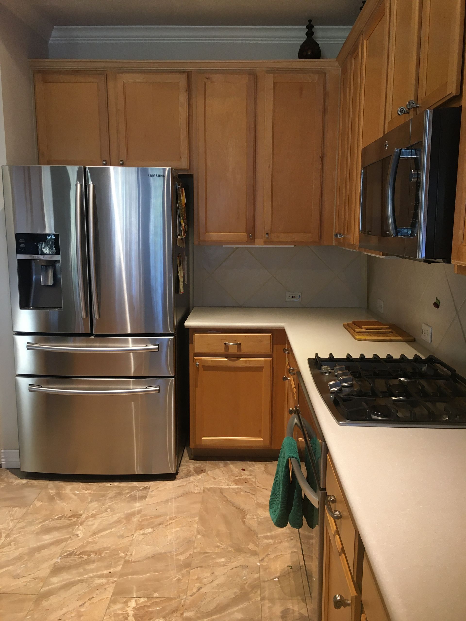 A kitchen with stainless steel appliances and wooden cabinets