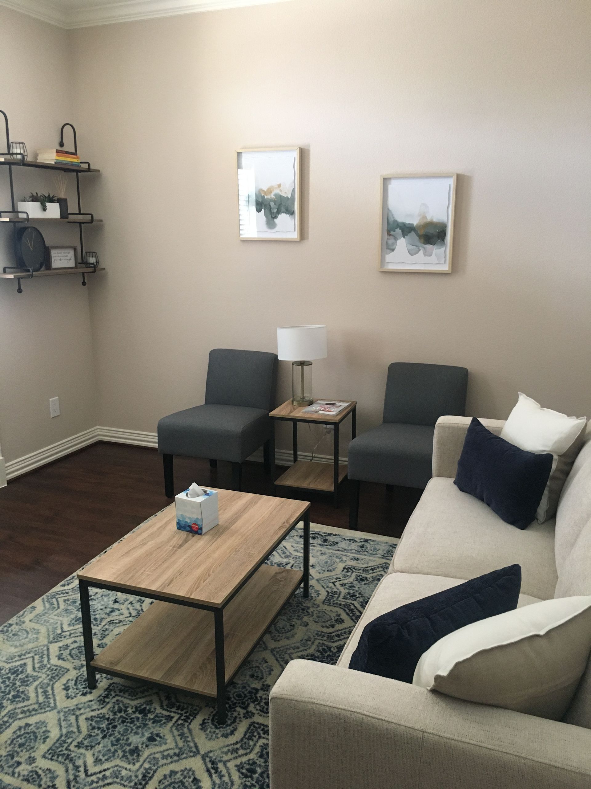 A living room with a couch , chairs and a coffee table