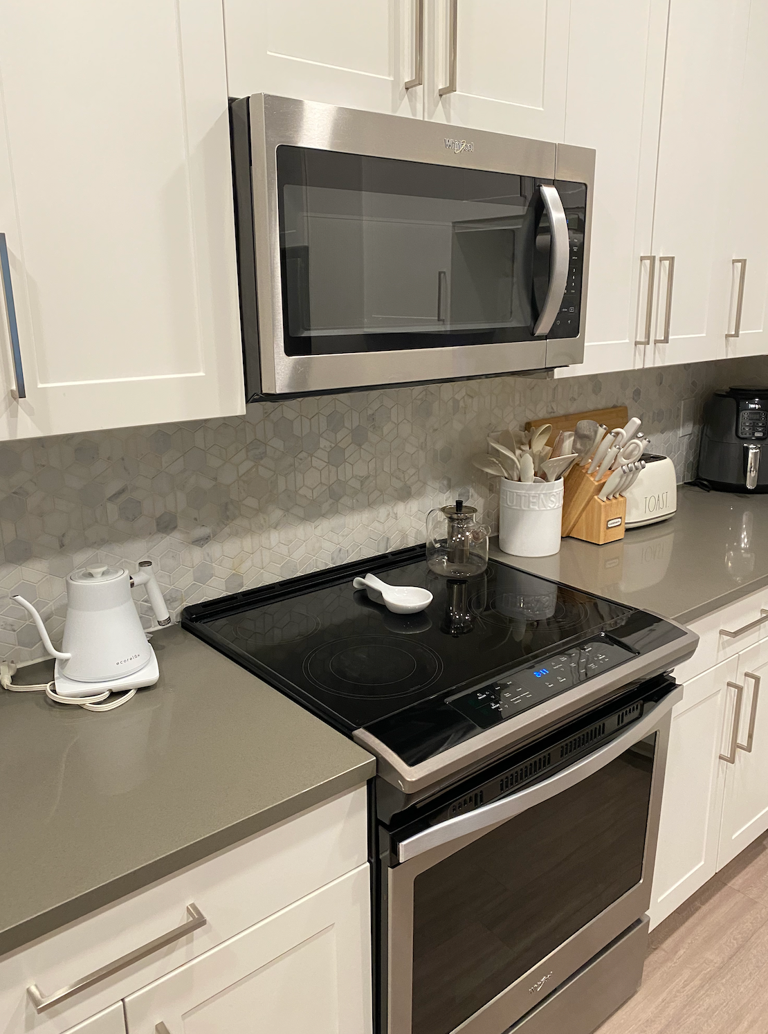 A kitchen with a stove , microwave , and dishwasher.