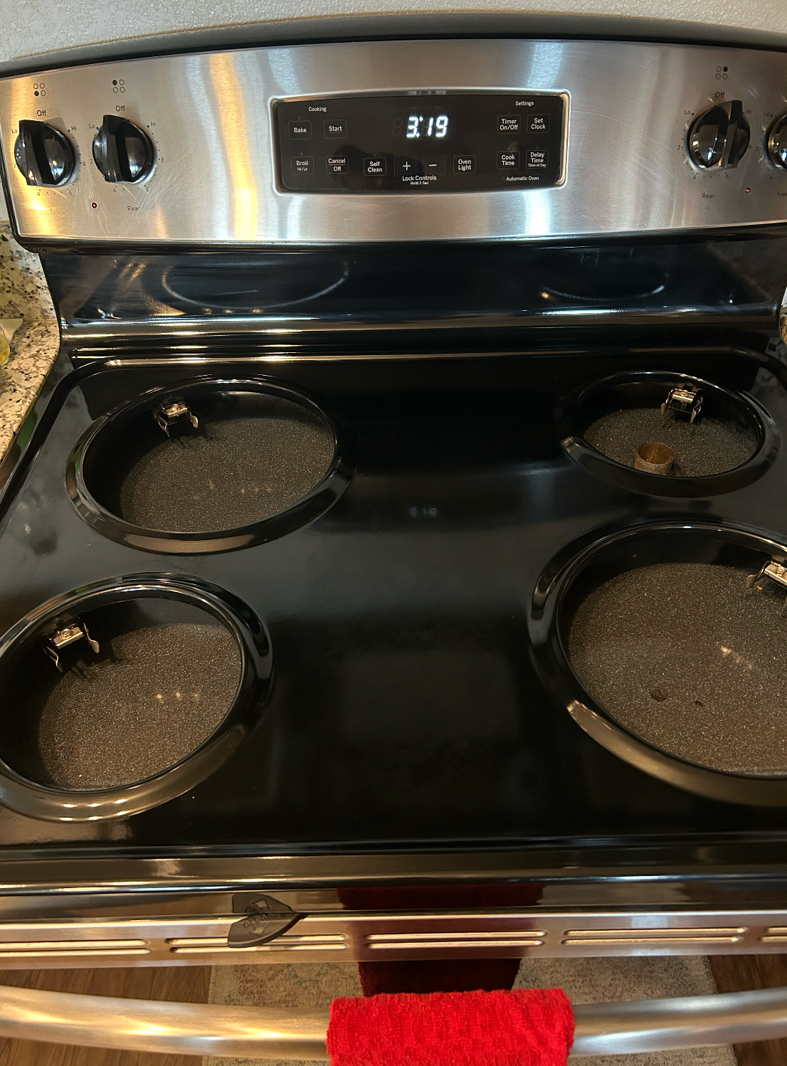 A stove top oven with four pots and pans on it.
