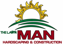 Logo for The Lawn Man Hardscaping & Construction featuring a yellow sun rising over green hills and red text.