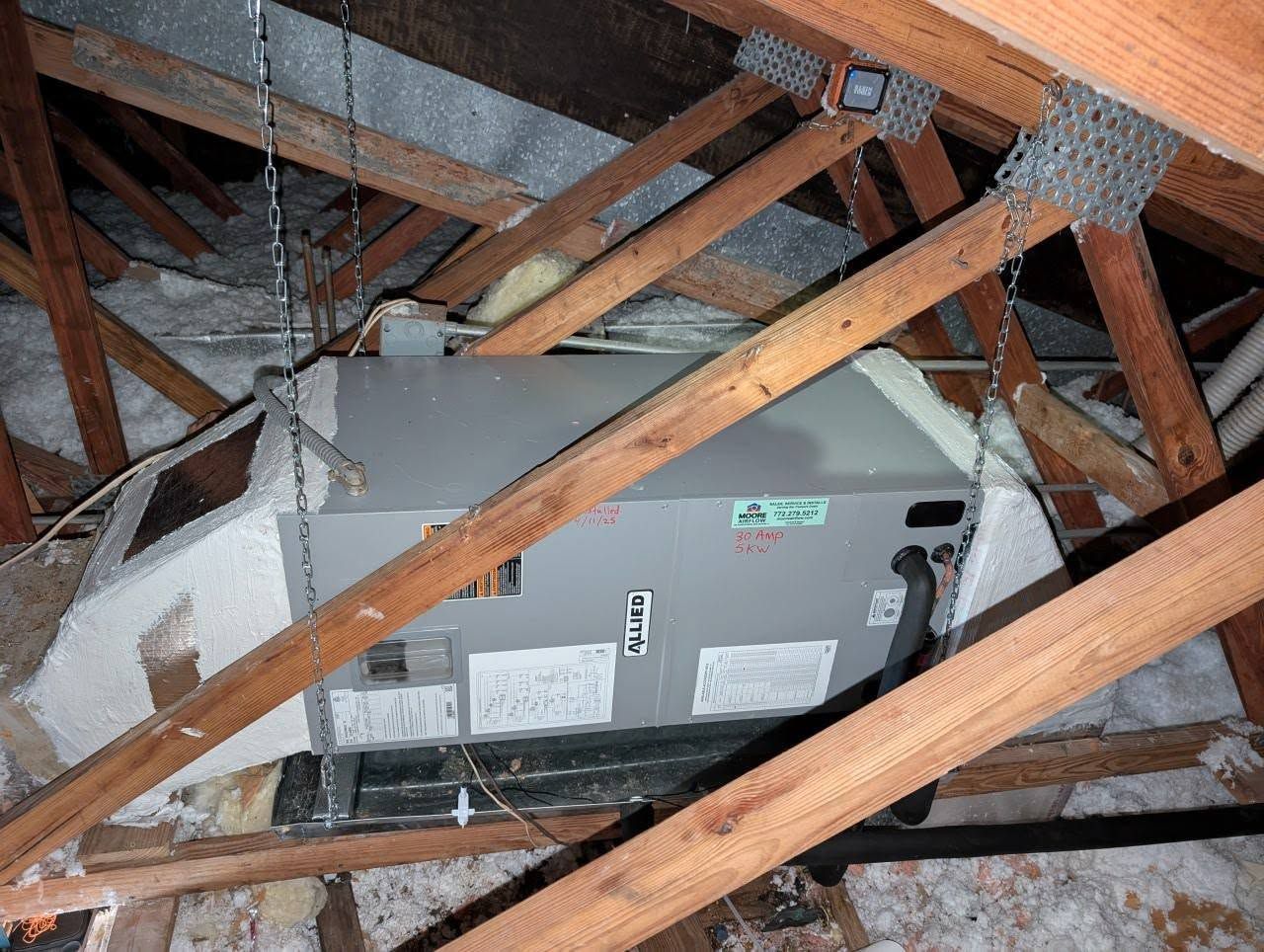 A box is hanging from the ceiling of a building.