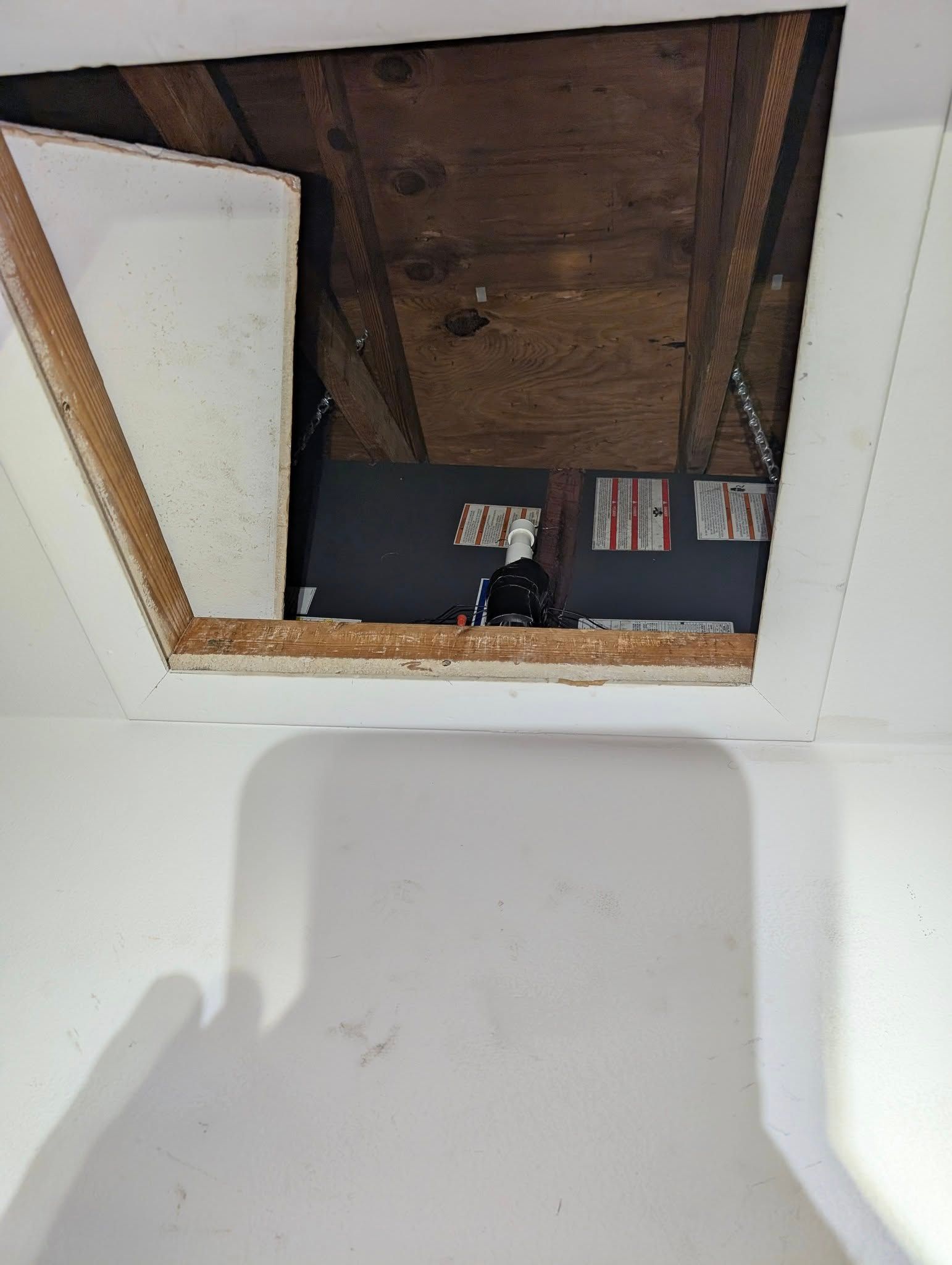 A shadow of a person is cast on a white wall