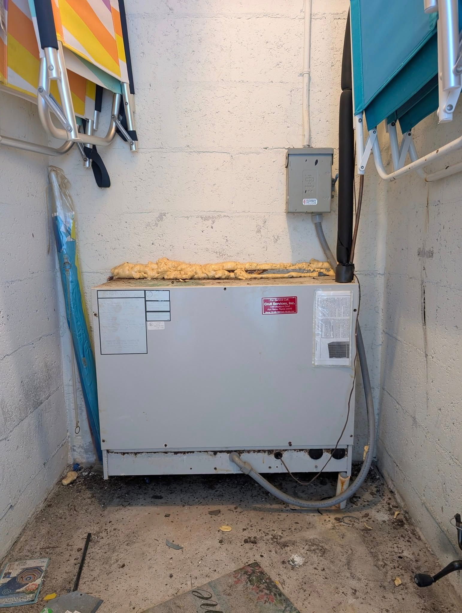 A dirty room with a washer and dryer in it