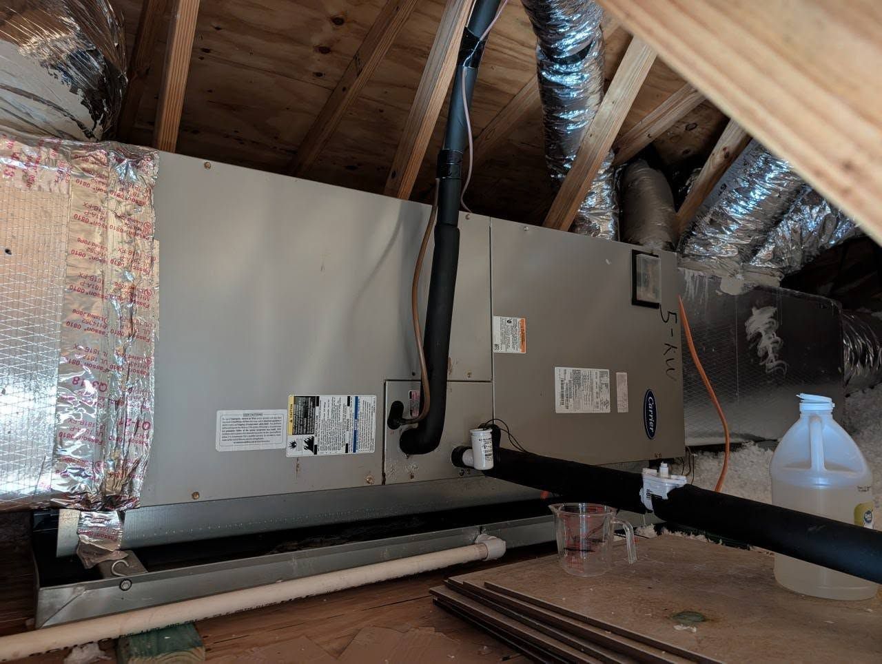 An air conditioner is installed in the attic of a house.
