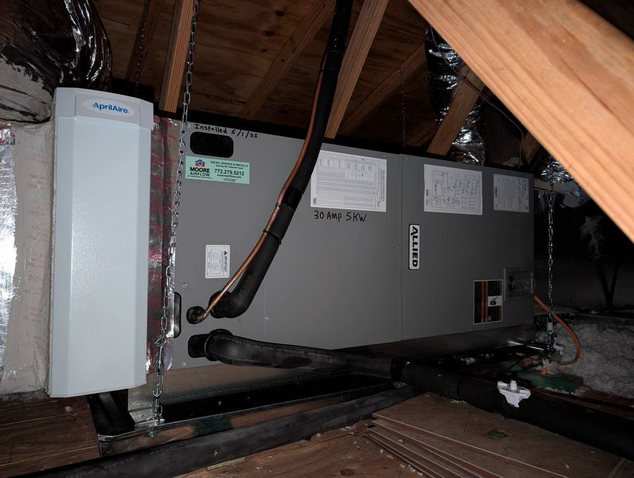 An air conditioner is installed in the attic of a house.