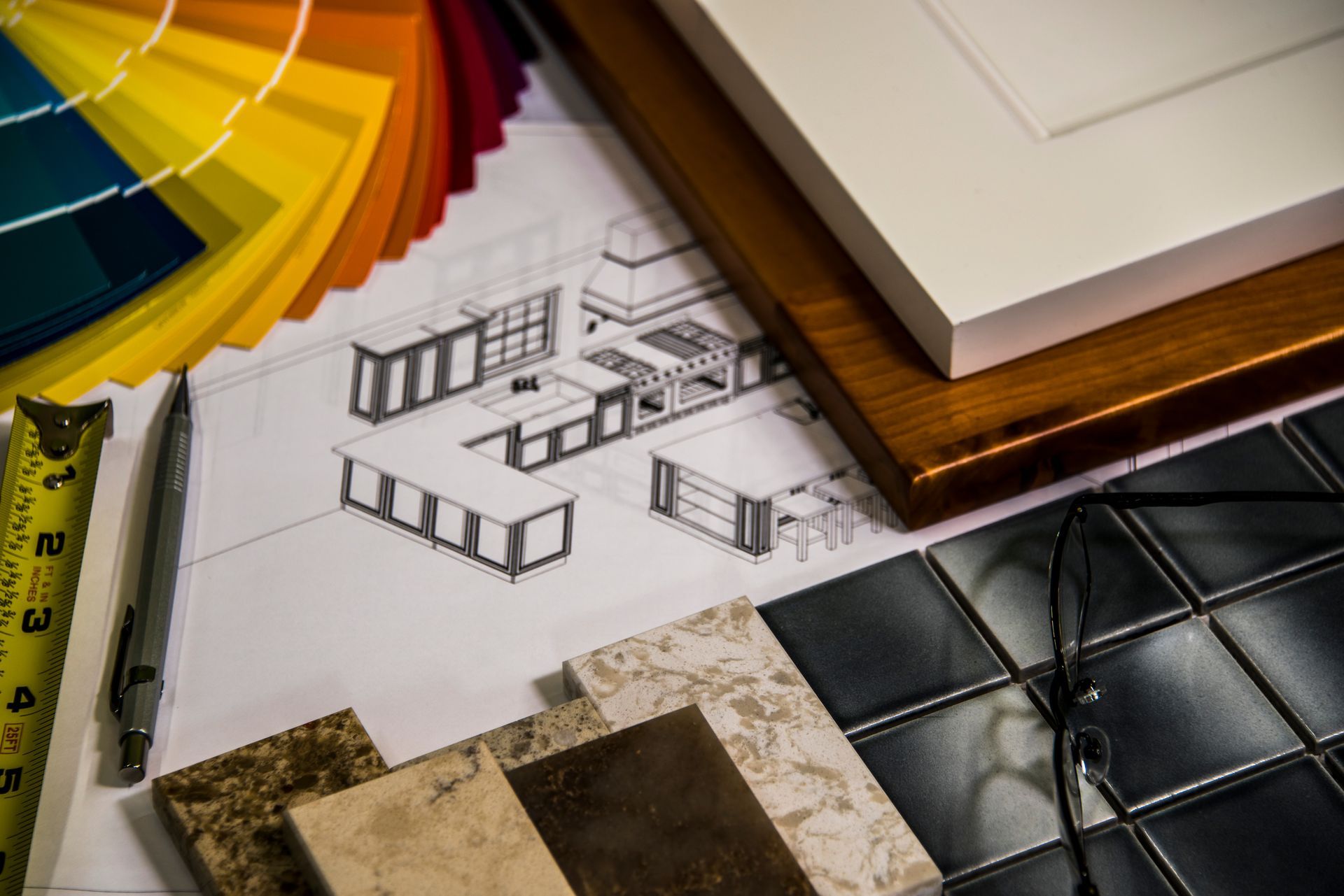 Kitchen design layout with paint swatches, cabinet samples, tile, and a measuring tape.