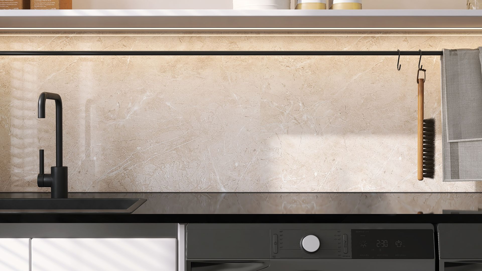 Kitchen countertop with black faucet, oven, and textured backsplash; hooks hold brush and towel.