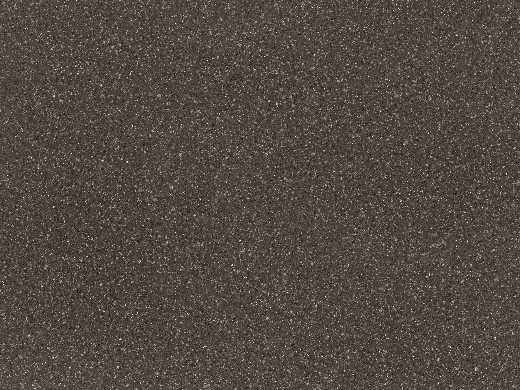 Dark, textured surface with small, scattered specks of lighter color.